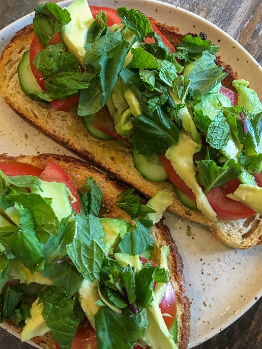 Nutritional avocado toast with vegetables and herbs