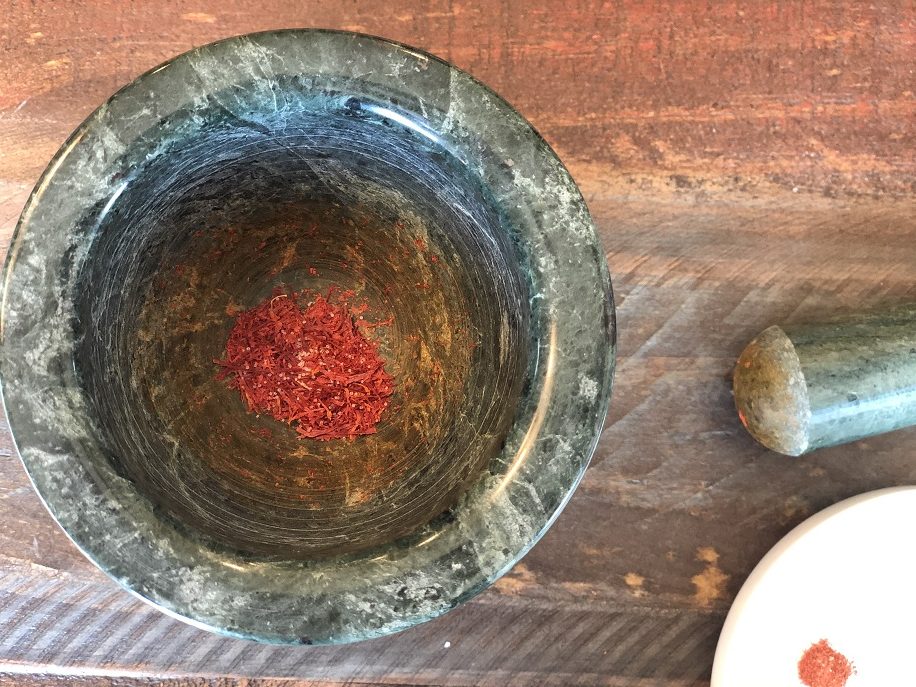 Saffron in mortar with salt or sugar