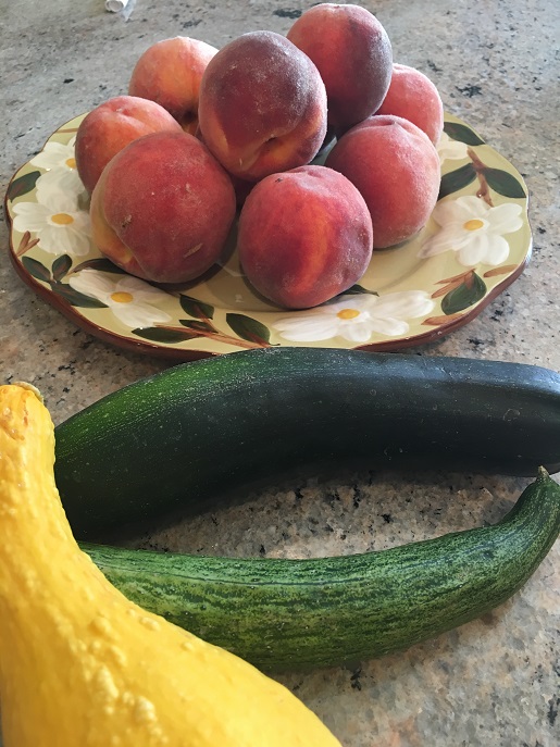 Garden produce zucchini, yellow squash and peaches