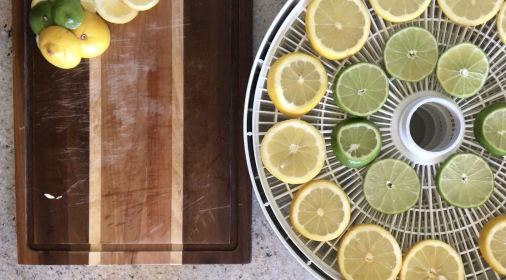 Prepared lemons and limes on the dehydrator