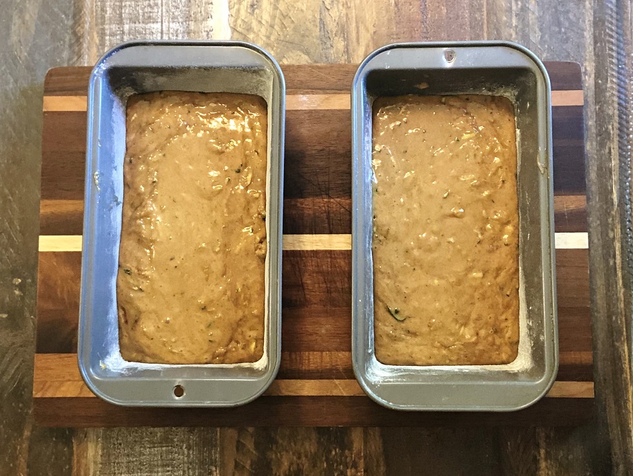 Zucchini batter divided into two loaf pans.